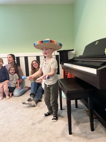 Child using maracas during a playful music activity
